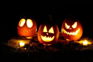 Glowing jack-o'-lantern on dried leaves for Halloween trick or treat night